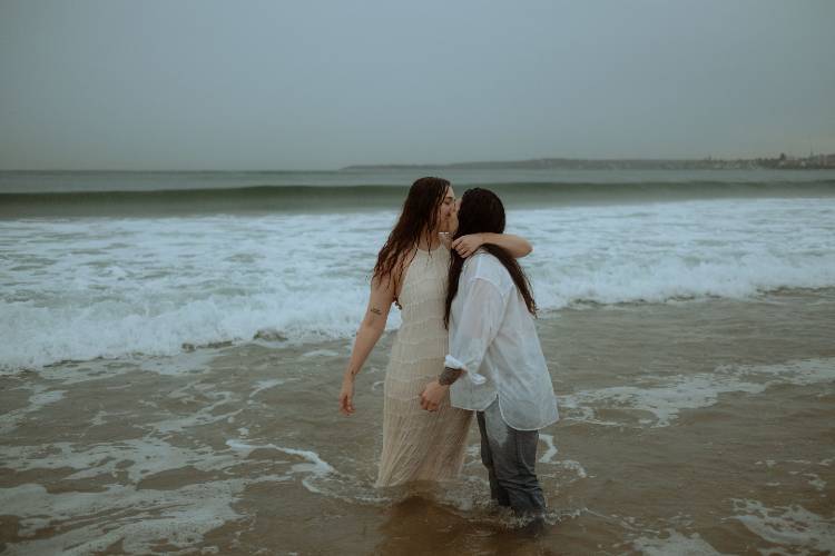 Beach engagement photo on rainy Sydney day by Sarah Van Treel