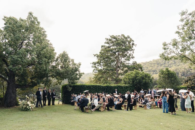 Garden ceremony on manicured lawn with hedges at Berry Hill