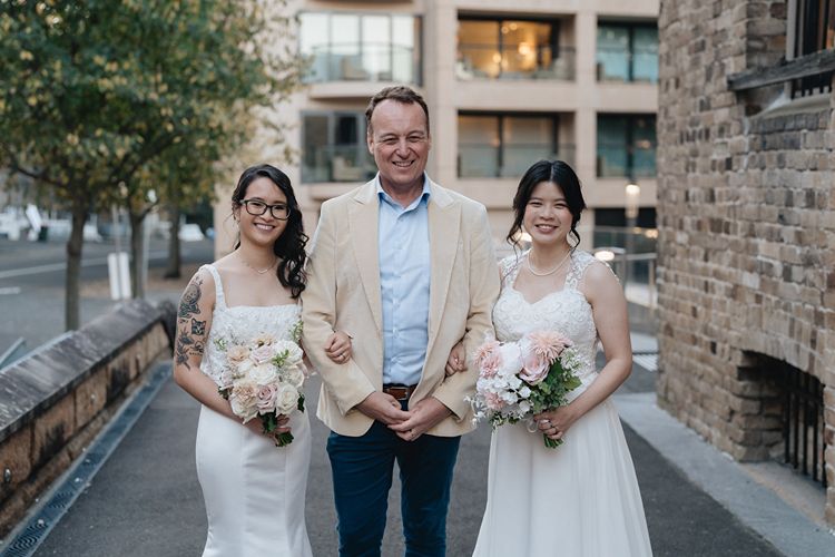 Gay celebrant Chris Stedman with two brides just married in a same sex ceremony