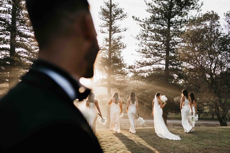 Groom watches bridal party at sunset by luxury Sydney photographer Paul Golbach