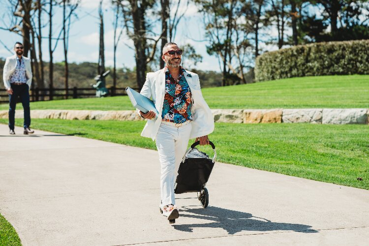 Modern male marriage celebrant & MC wearing a crisp white suit