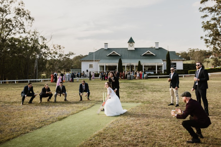 Bridal party playing cricket at NSW wedding destination Wandin Valley