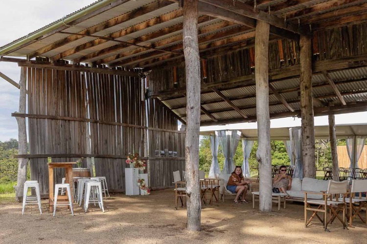 Rustic outdoor wedding venue in an open machinery shed at Kiruna Farm