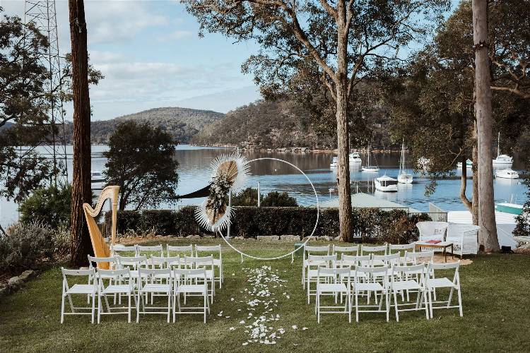 Waterfront wedding ceremony at affordable wedding venue Elouera Cottage Point