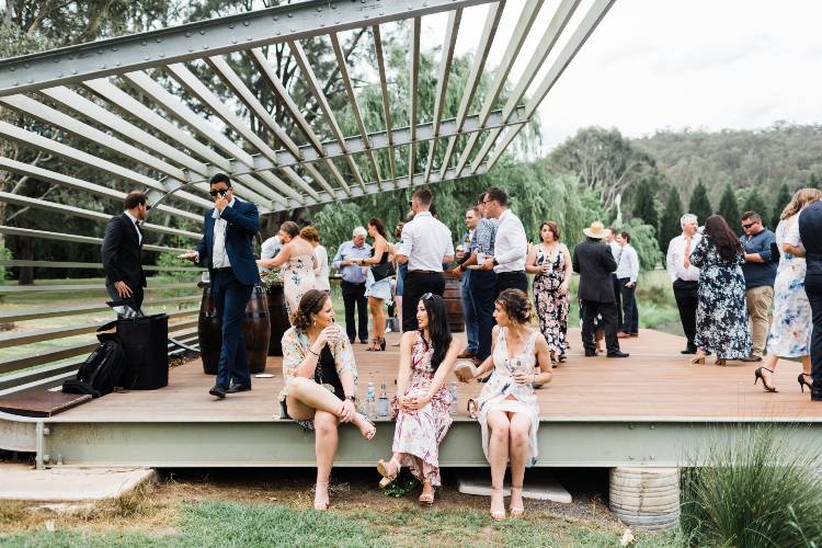 Guests enjoying cocktail hour on the cantilever dec at The Woodhouse Wollombi